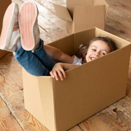 Internal moving service page image of a happy child playing in a box