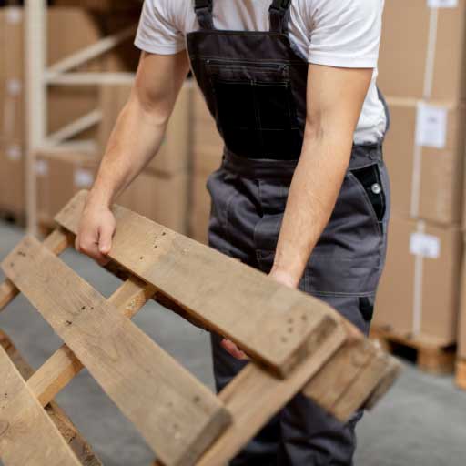 Moving business page image of a man moving a pallet