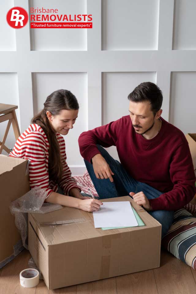 Moving checklist 2024 article image of a happy couple checking their moving list