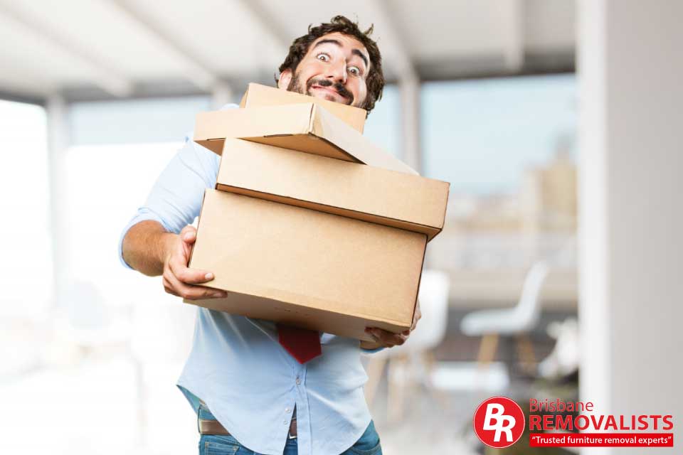 Risks of cheap moving companies article image of crazy guy carrying boxes