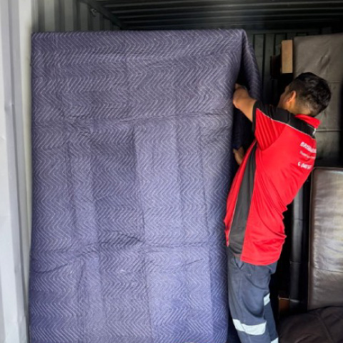 Acrew mwmber wrapping an item in our truck at Brisbane Removalists