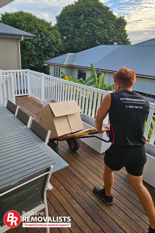 Removalists Mount Gravatt Removalists Mount Gravatt page image of one of our team moving boxes on a veranda
